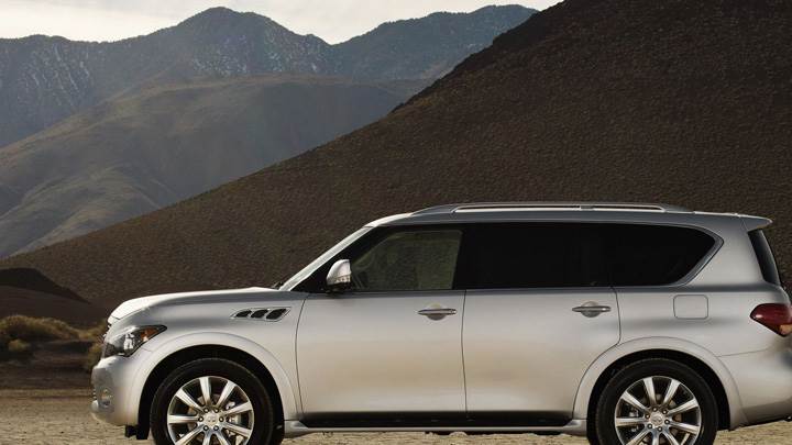 Side Pose Of 2011 Infiniti QX56 In White Near Moutains